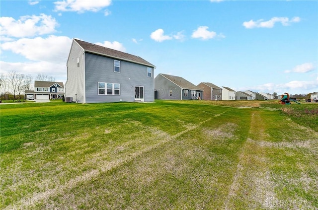 rear view of property with a yard