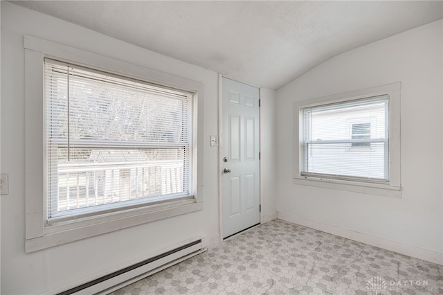 doorway featuring a baseboard radiator and vaulted ceiling