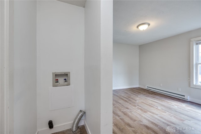 laundry room with a baseboard radiator, washer hookup, and light hardwood / wood-style flooring