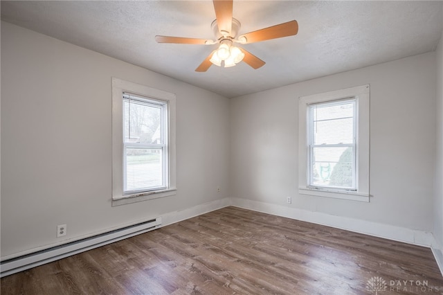 unfurnished room featuring a baseboard radiator, hardwood / wood-style floors, ceiling fan, and a textured ceiling