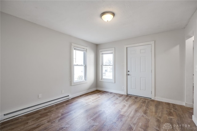 entryway with a baseboard heating unit and light hardwood / wood-style flooring