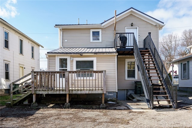 back of house with a wooden deck