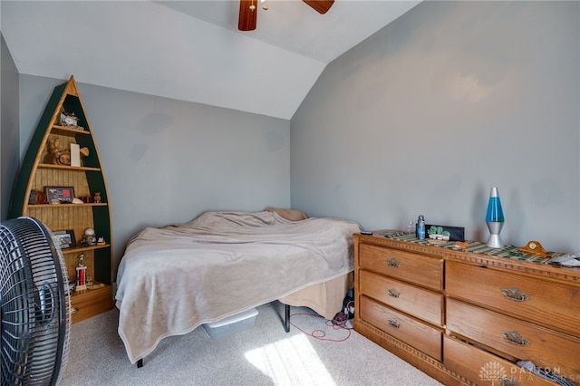 bedroom with ceiling fan, carpet floors, and vaulted ceiling