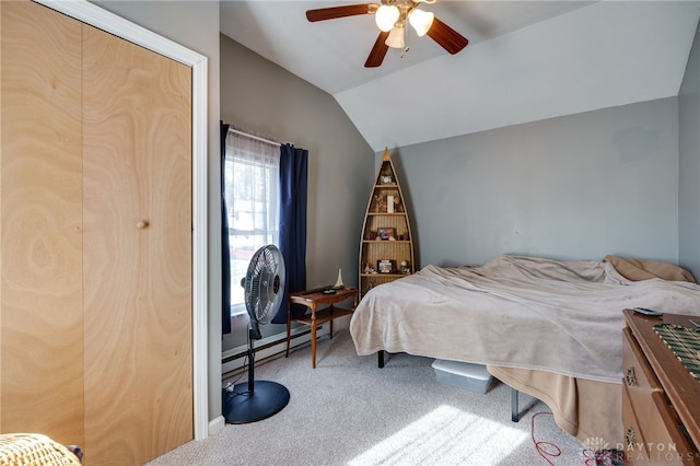 bedroom featuring a baseboard radiator, lofted ceiling, carpet flooring, and ceiling fan