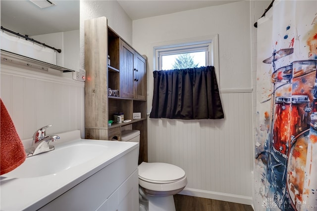 bathroom with a shower with curtain, vanity, toilet, and hardwood / wood-style floors