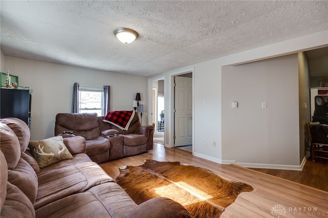 living room featuring hardwood / wood-style flooring and a textured ceiling