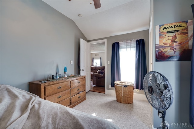 carpeted bedroom with vaulted ceiling and ceiling fan