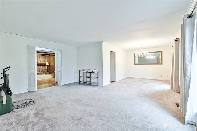 carpeted empty room featuring crown molding and a notable chandelier