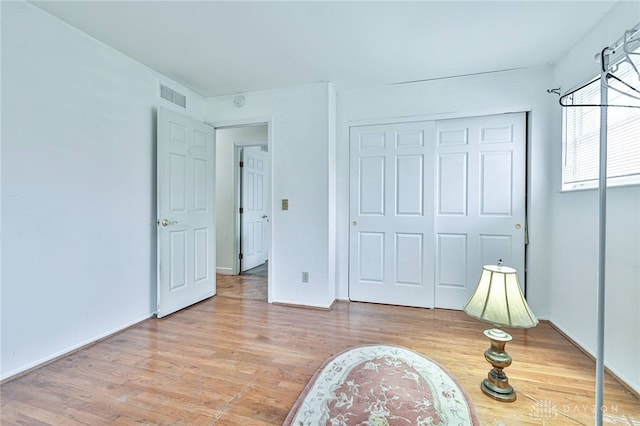 bedroom featuring hardwood / wood-style floors and a closet