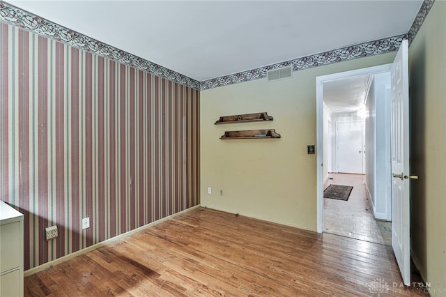 spare room featuring hardwood / wood-style floors