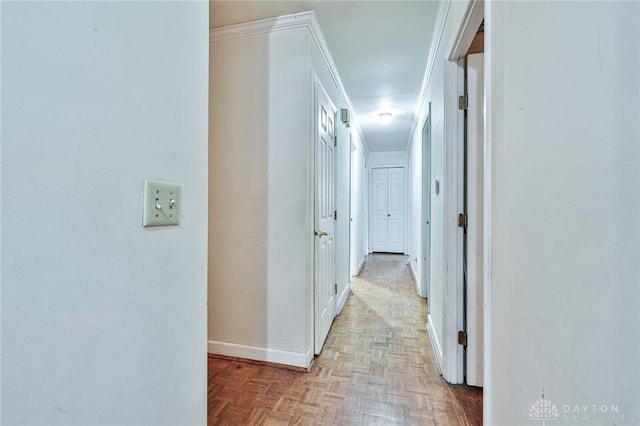 corridor with crown molding and light parquet floors