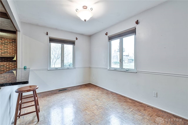 spare room with parquet flooring