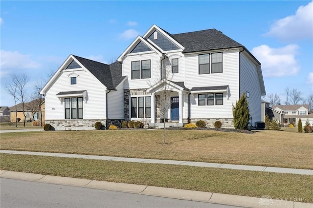 view of front of house with central AC and a front lawn