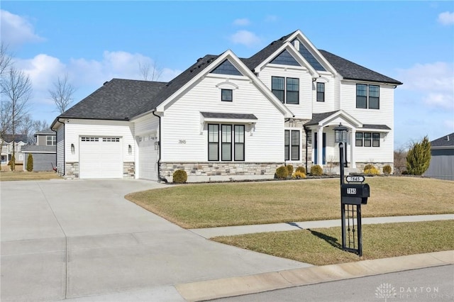 view of front of property featuring a garage and a front lawn