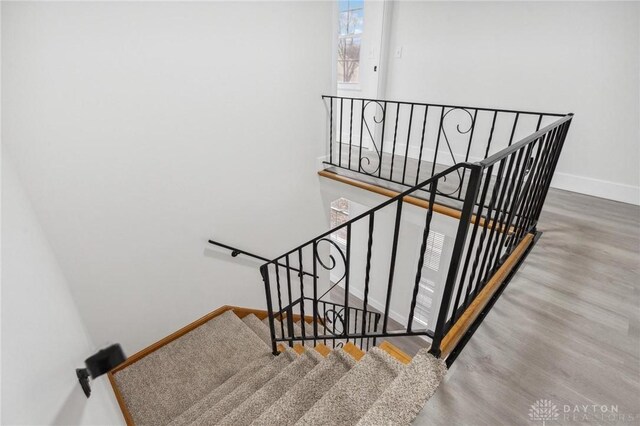 stairs featuring hardwood / wood-style flooring