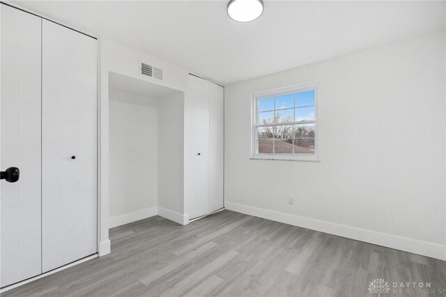 unfurnished bedroom featuring light wood-type flooring