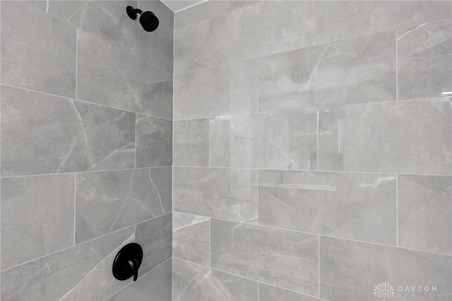 interior details with tiled shower / bath combo