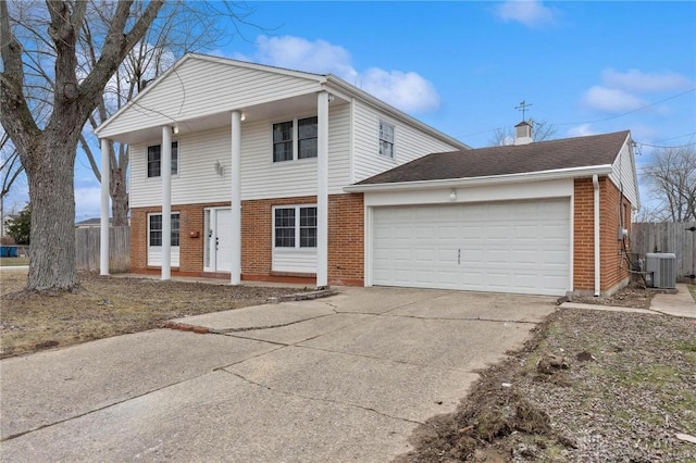 view of front property featuring a garage and central AC unit