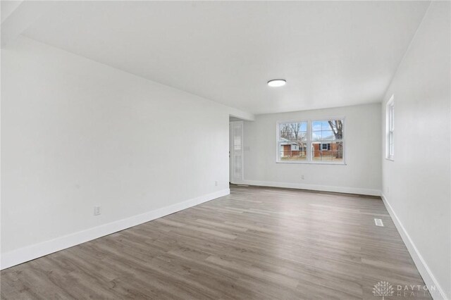 spare room with hardwood / wood-style floors