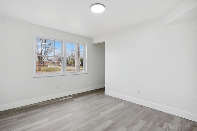 unfurnished room featuring light hardwood / wood-style floors