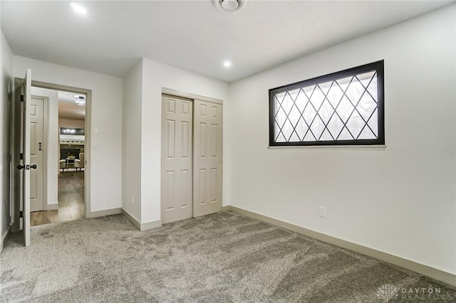 unfurnished bedroom with carpet floors and a closet