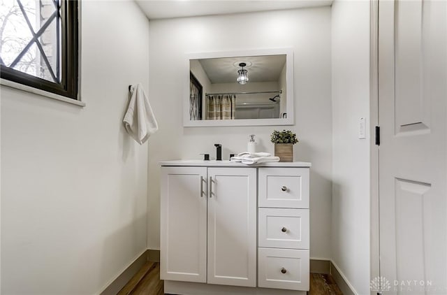 bathroom with vanity and wood-type flooring