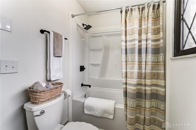 bathroom featuring shower / bathtub combination with curtain and toilet