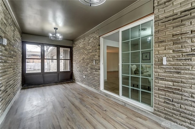 unfurnished sunroom featuring an inviting chandelier