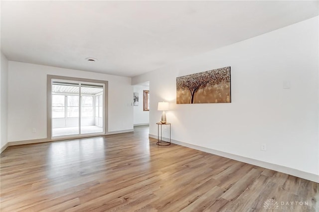 unfurnished room with light wood-type flooring