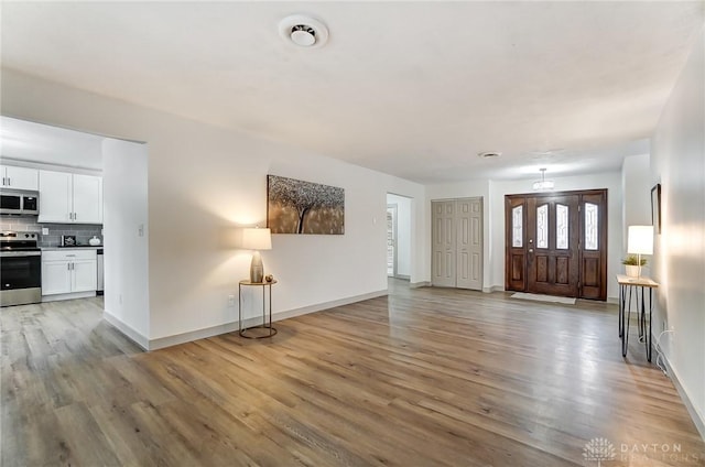 foyer entrance with light hardwood / wood-style flooring