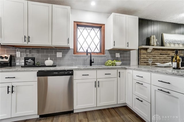 kitchen featuring white cabinetry, dishwasher, sink, and light stone counters