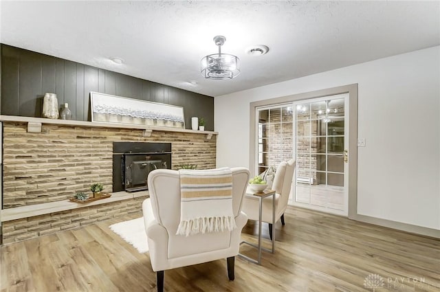 dining area featuring a brick fireplace and light hardwood / wood-style floors