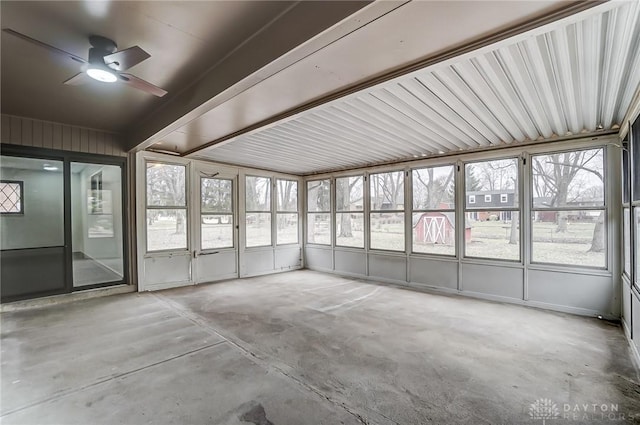 unfurnished sunroom with ceiling fan and plenty of natural light