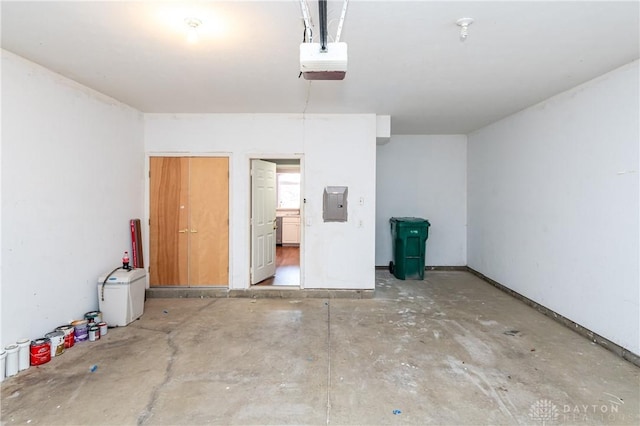 garage with a garage door opener and electric panel