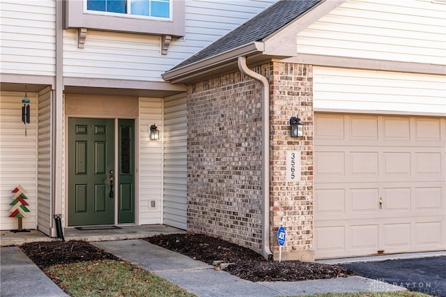 view of exterior entry featuring a garage