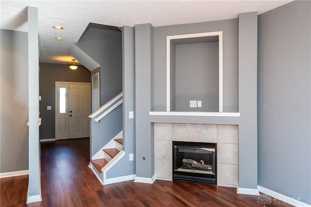 interior space featuring dark hardwood / wood-style flooring and a tile fireplace