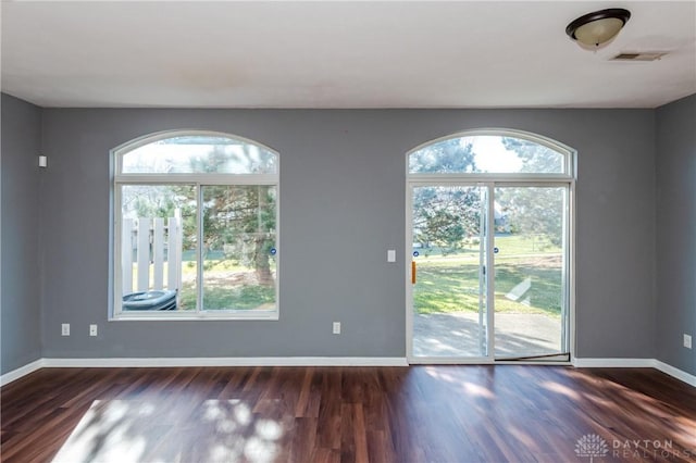 unfurnished room featuring dark wood-type flooring