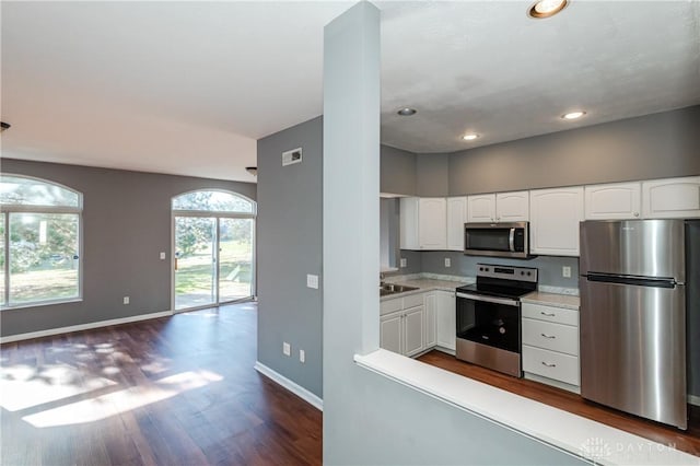 kitchen with white cabinetry, sink, dark wood-type flooring, and stainless steel appliances