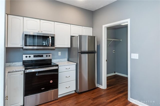 kitchen featuring dark hardwood / wood-style floors, white cabinets, and appliances with stainless steel finishes