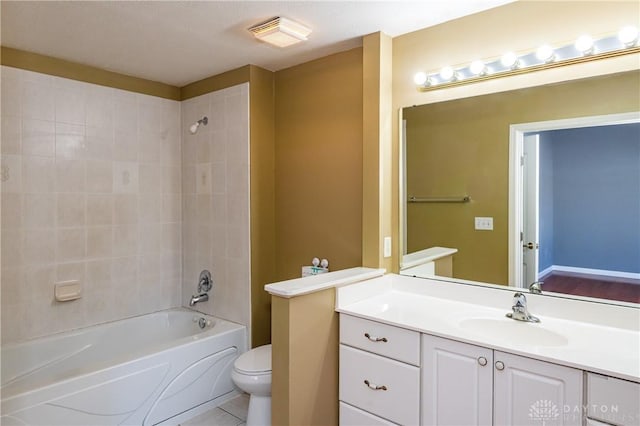 full bathroom with tiled shower / bath combo, vanity, and toilet