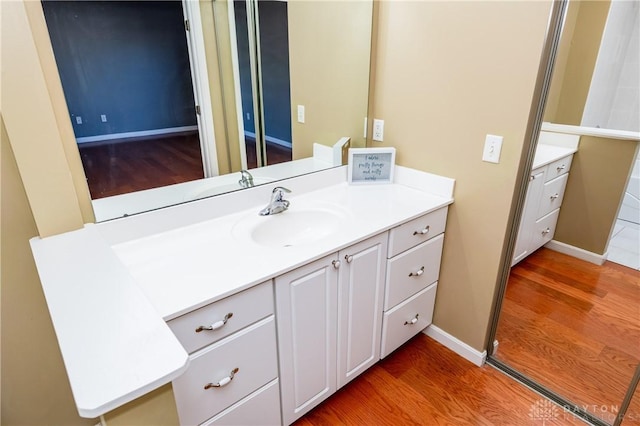 bathroom featuring hardwood / wood-style flooring and vanity