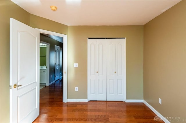 unfurnished bedroom featuring hardwood / wood-style floors and a closet