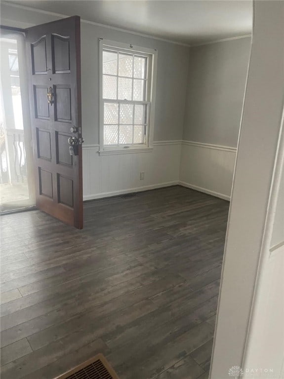 foyer featuring dark hardwood / wood-style flooring and ornamental molding