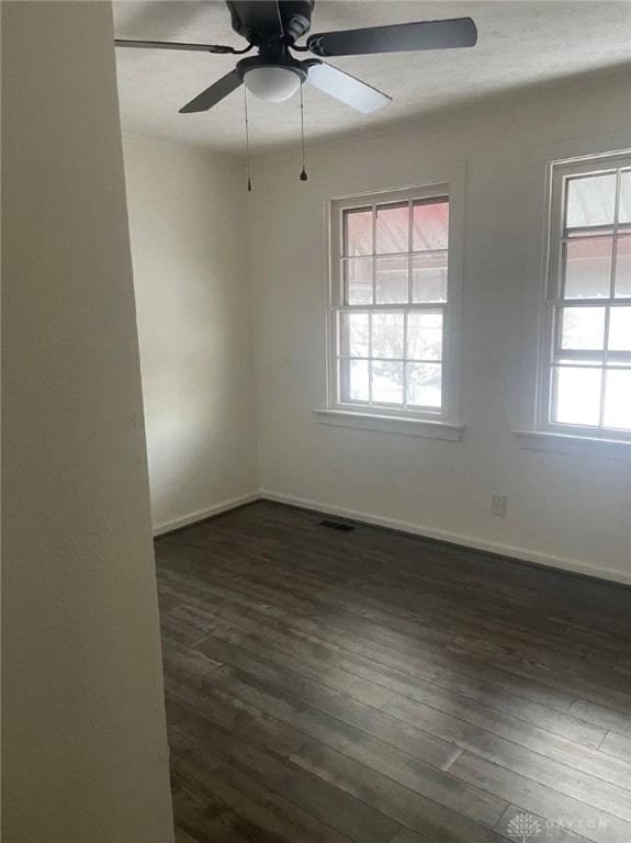 spare room featuring dark hardwood / wood-style flooring and ceiling fan