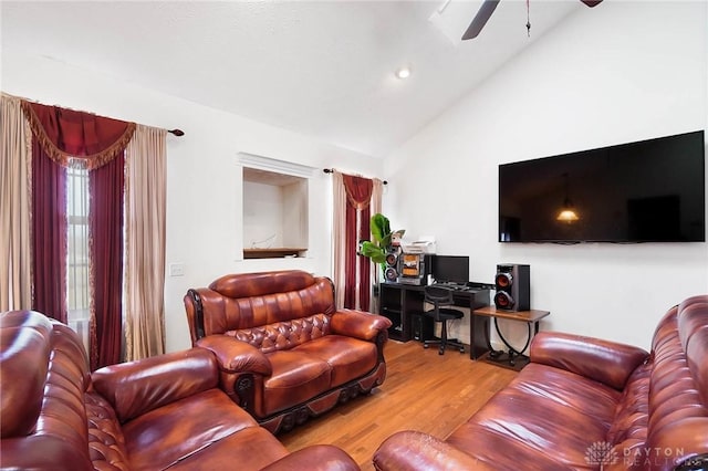 living room with ceiling fan, lofted ceiling, and wood-type flooring