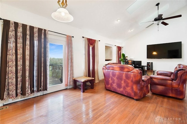 living room with hardwood / wood-style flooring, high vaulted ceiling, and ceiling fan