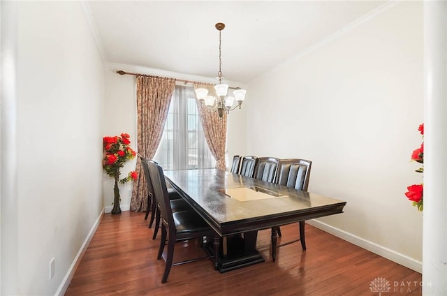 dining area with wood-type flooring, a chandelier, and crown molding