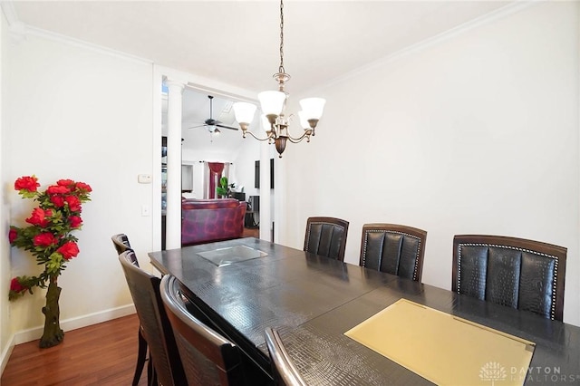 dining area with ornate columns, crown molding, dark hardwood / wood-style floors, and ceiling fan with notable chandelier