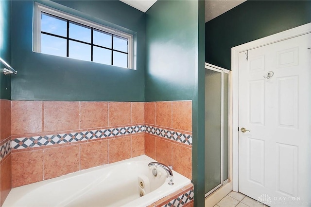 bathroom featuring tile patterned flooring and separate shower and tub