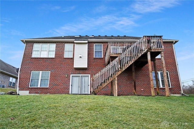 rear view of property featuring a wooden deck and a yard